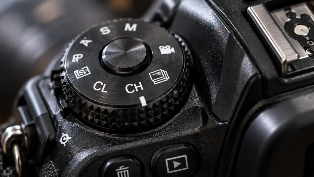A close up of a camera dial showing what is camera continuous shooting settings.